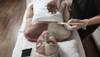 Spa Worker Applying Clay Mask