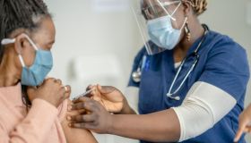 Senior African Woman Receiving the COVID-19 Vaccine Medical Injection