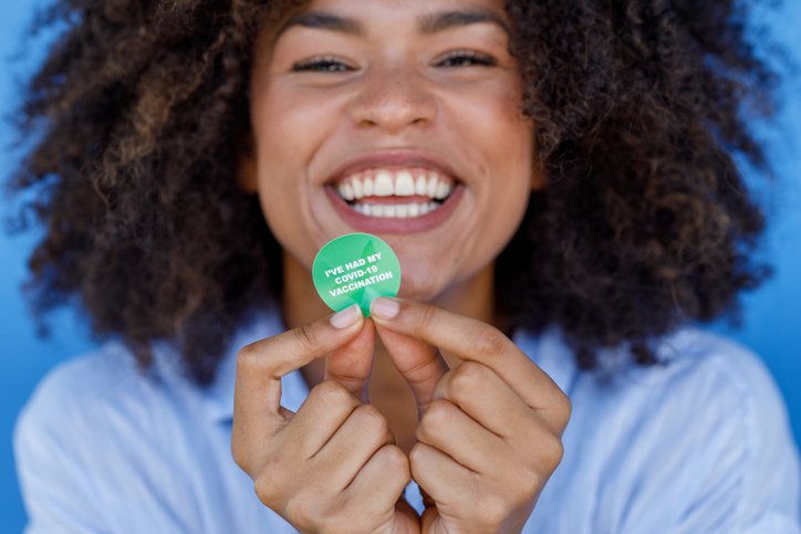 African Woman With COVID-19 Vaccine Sticker