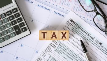 Tax Deadline. Tax Form 1040 on Working Desk.