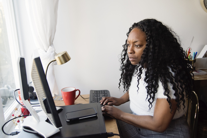 Woman working from home in small space.