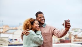Happy Man Taking Selfie With Girlfriend At Rooftop