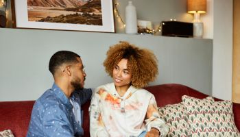 Young Man With Girlfriend In Living Room
