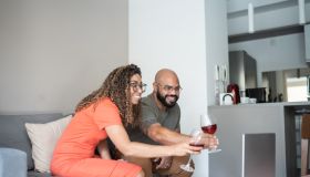 Couple drinking wine during a virtual happy hour at home
