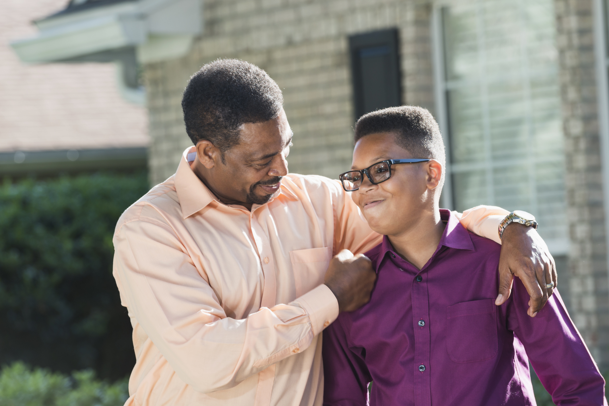Proud African American father with teenage son