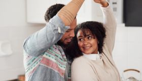 Shot of a young couple dancing in their kitchen at home