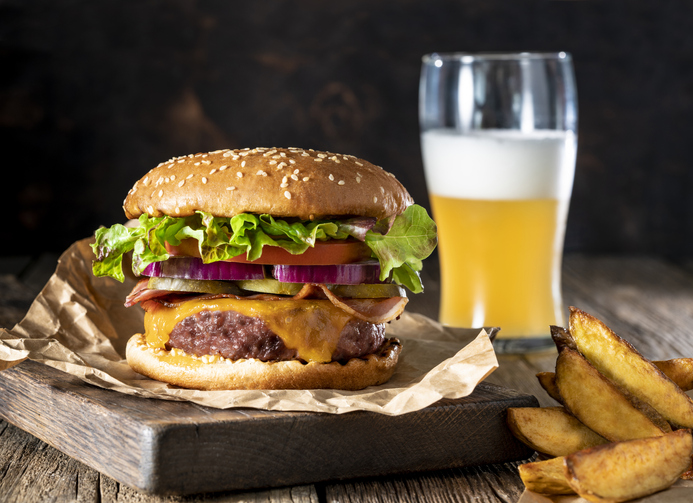 Cheeseburger Burger Patty classic with french fries and beer menu on rustic board of wood