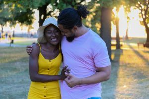 Young African Couple in Love is Walking in Public Park and Feeling Happy.