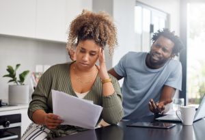 Shot of a couple having an argument while going over their finances at home