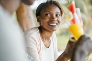 Happy black couple enjoying in summer drink at a cafe.