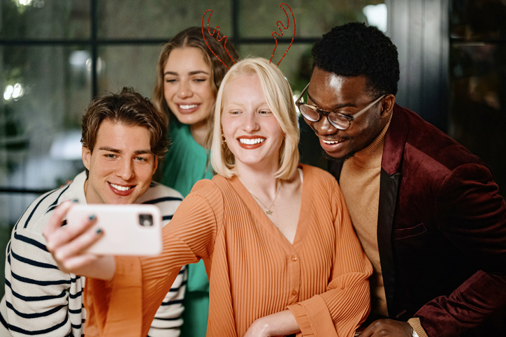 Friends posing for a selfie while celebrating New Year's Eve