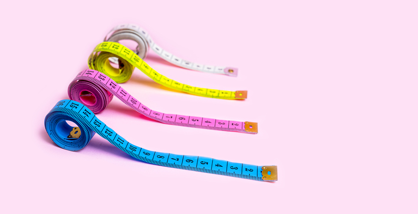 Set of Colored Tapes Measure on Pastel Pink Background.