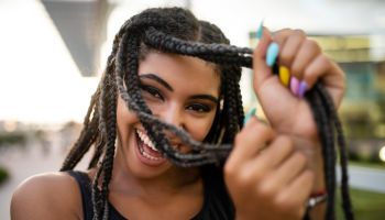 Afro-american teenage model flaunting box braids hairstyle