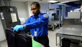 (032610, Boston, MA) Transportation Security Administration lead officer (most of the inspectors have this title) Ian Abreau-Riley inspects a bag inside one of the TSA's bag inspection areas at Logan International Airport on Friday, March 26, 2010. S