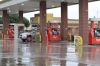 A customer pumps gas into his car at a Kroger gas station on a rainy day