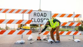 Hispanic Workers Setting Barriers and Directing Traffic Street Road and Highway Construction Photo Series