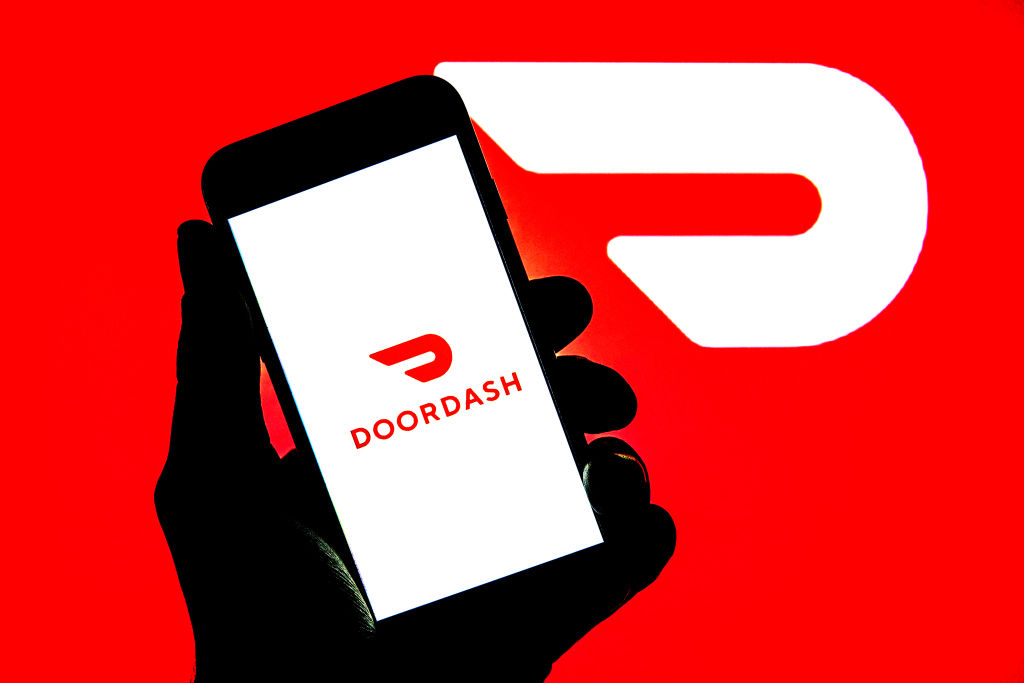 In this photo illustration, a DoorDash logo seen displayed...