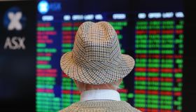 A retiree watches stock prices fall on t