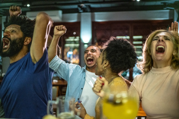 Sports friends fans watching match and celebrating at bar