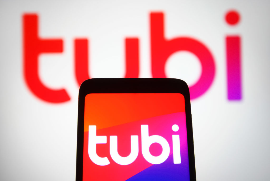 In this photo illustration, a Tubi logo is seen on a...