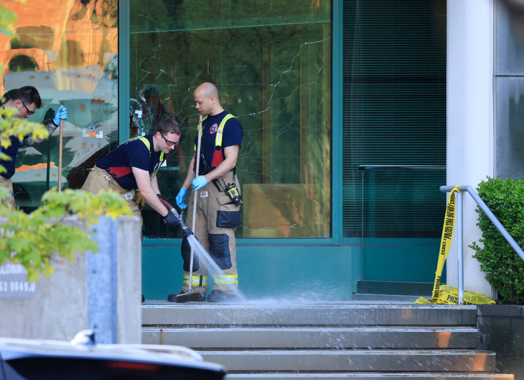 Members of the Louisville Fire Department clean steps of the...