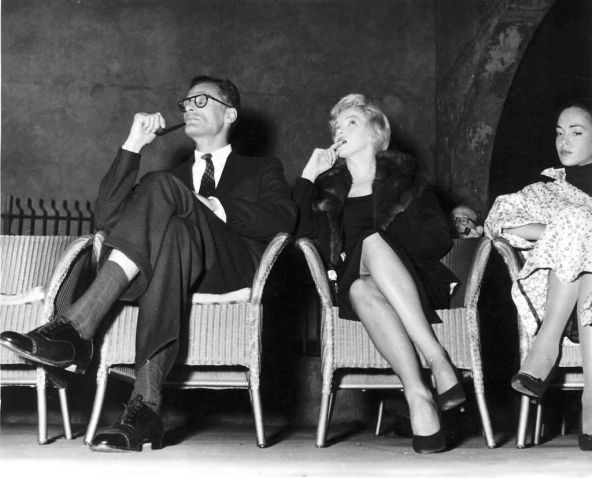 Marilyn Monroe and her husband Arthur Miller watch a performance of his new play A View From The Bridge in London September 1956