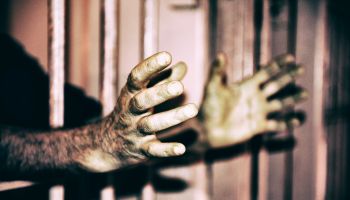 Prisoner Hands through the bars.
