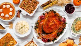 Delicious Thanksgiving turkey dinner. Above view table scene on a rustic white wood background. Turkey, mashed potatoes, stuffing, pumpkin pie and sides.
