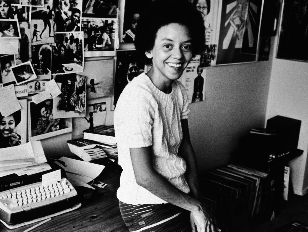 Poet Nikki Giovanni Leans On Her Desk