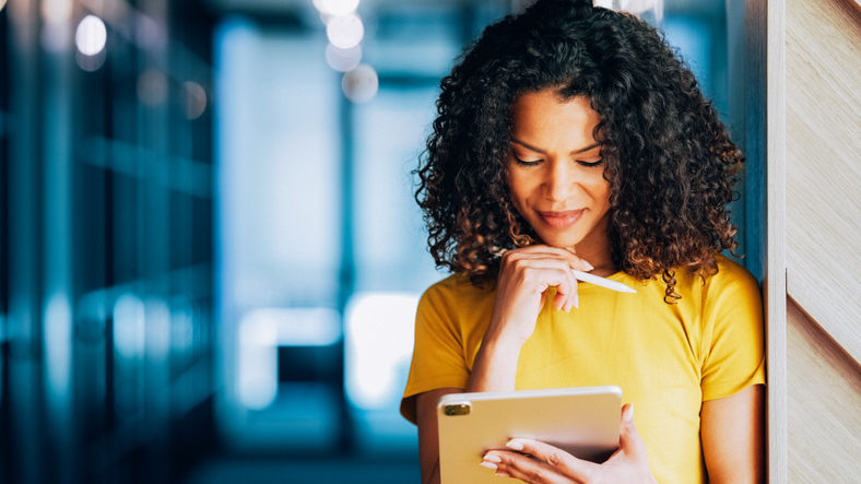 Businesswoman signing a digital document on a tablet