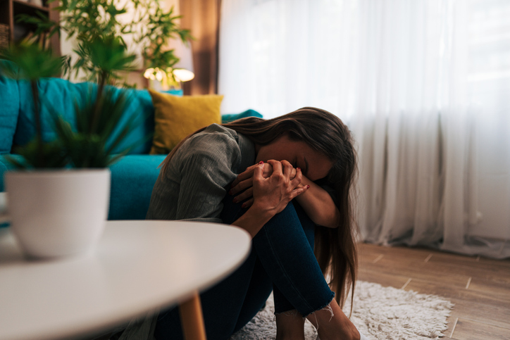 Young woman feeling hopeless and depressed at home