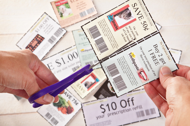 Woman's Hands Cutting Coupons