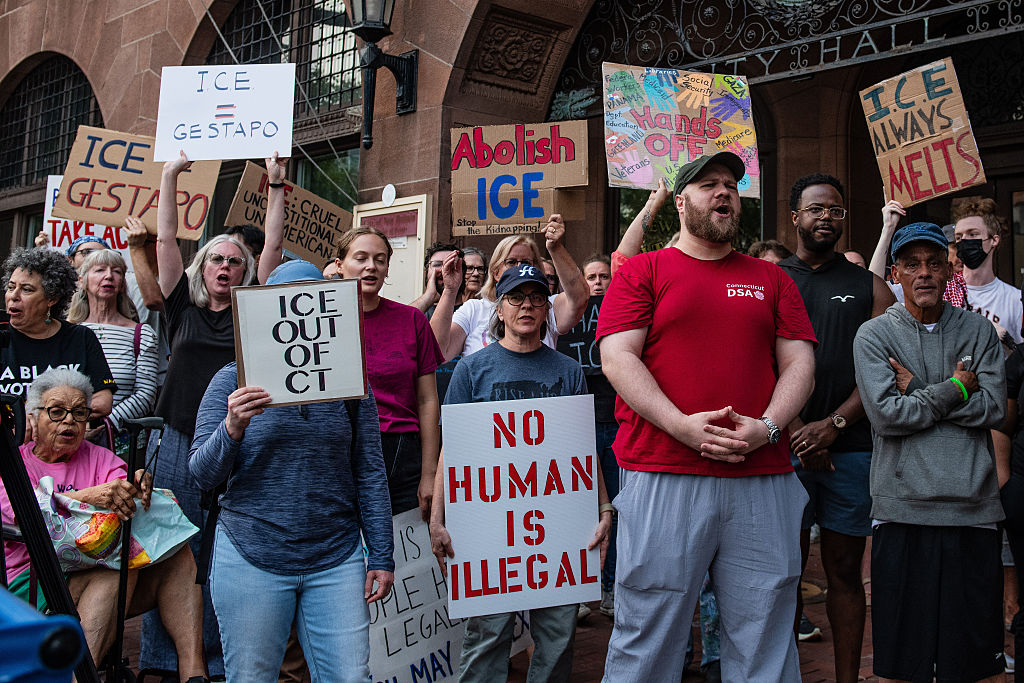 Protesters gather at the city hall with placards to protest...