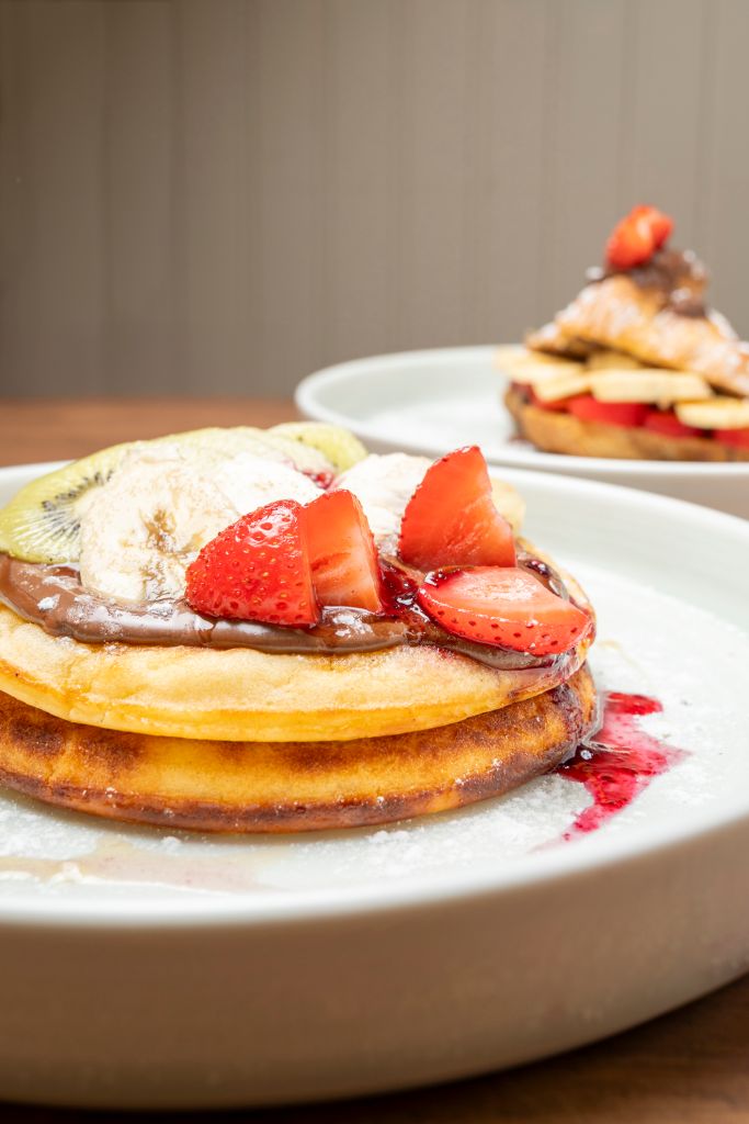 Pancakes with chocolate, strawberry, banana and kiwi for breakfast