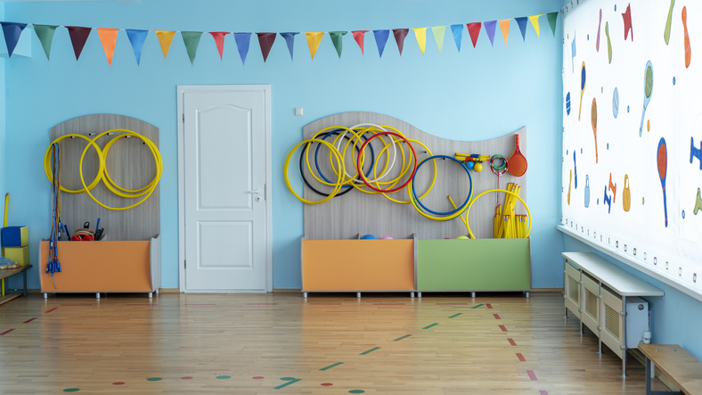 Bright children's activity room equipped with various sports tools and colorful decorations, providing space for play and physical development