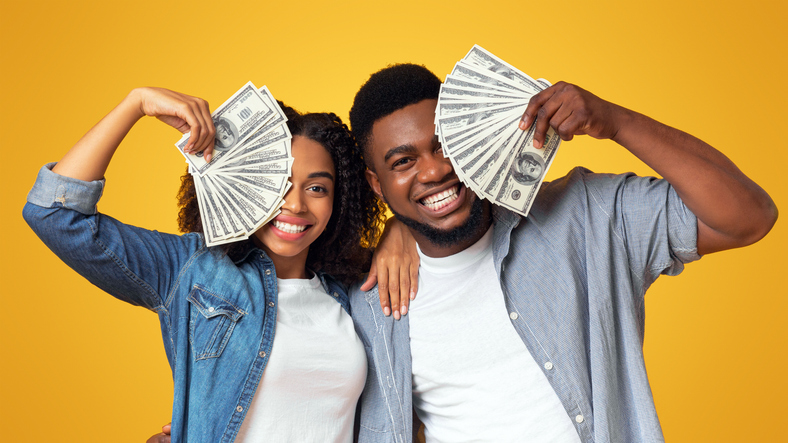Lucky black man and woman holding lots of dollar cash