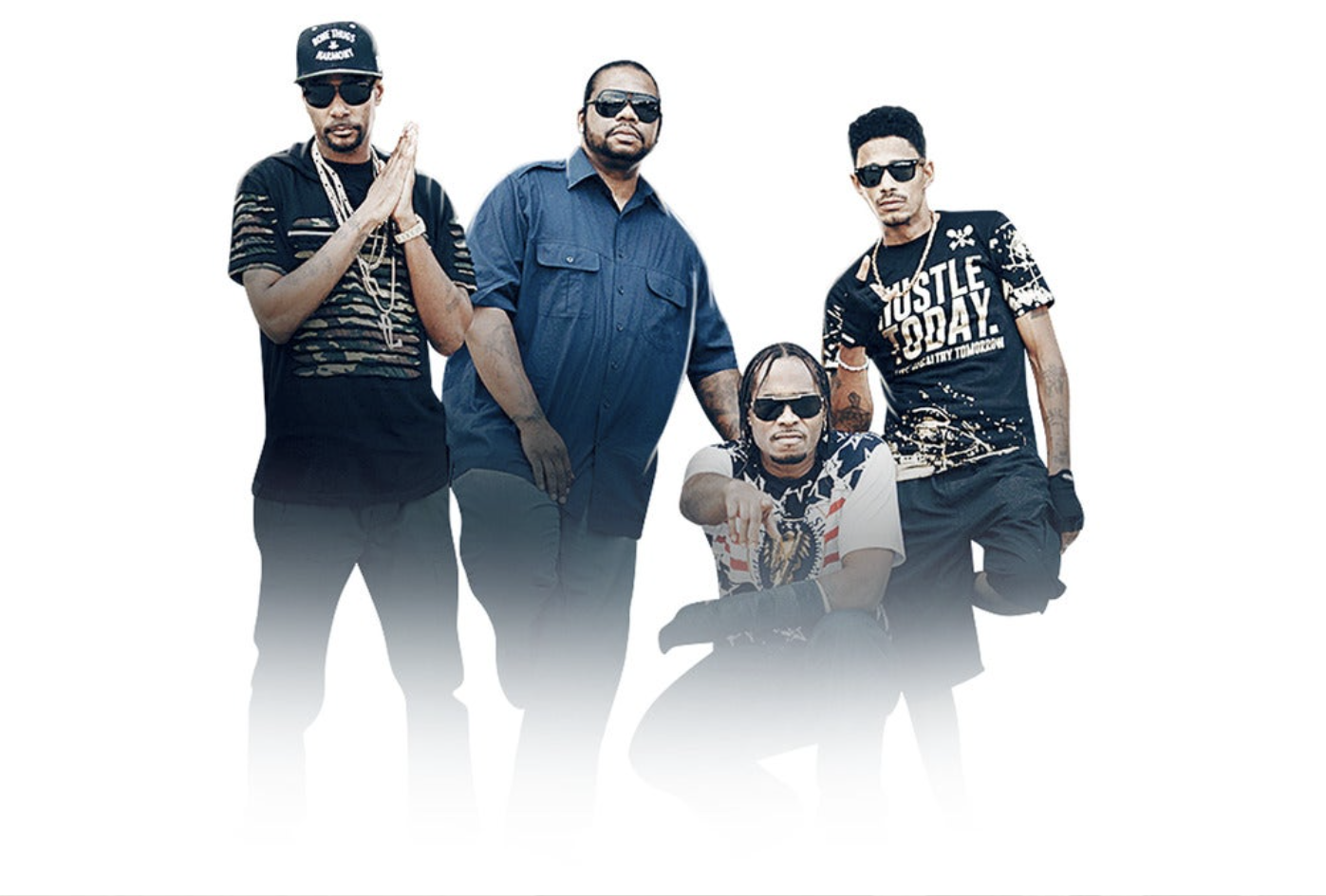Four men wearing sunglasses and casual clothing, posing together in a studio setting.