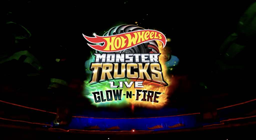 Hot Wheels Monster Trucks Live Glow-n-Fire logo on a dark background with colorful lights and explosions.