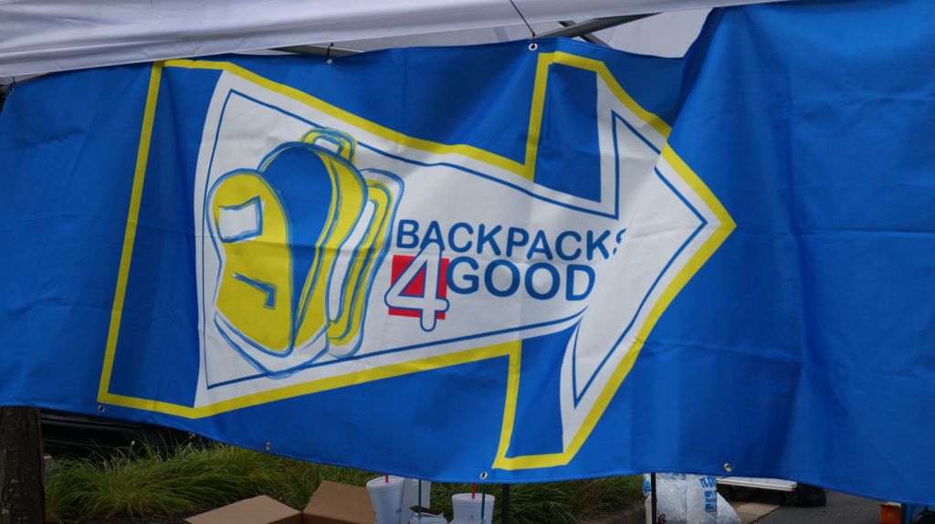 Blue and yellow banner with "Backpack 4 Good" logo and arrow