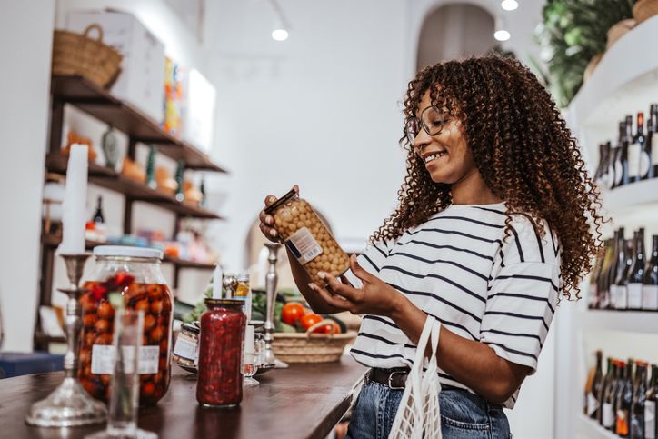 Young black woman shopping for groceries in a store during the day